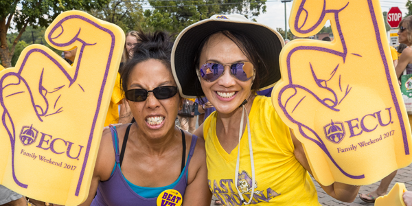 two people posing with college foam hands